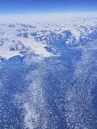 High angle view of snowcapped mountain against blue sky