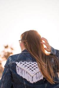 Midsection of woman against clear sky during winter