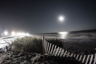 Scenic view of sea against clear sky at night