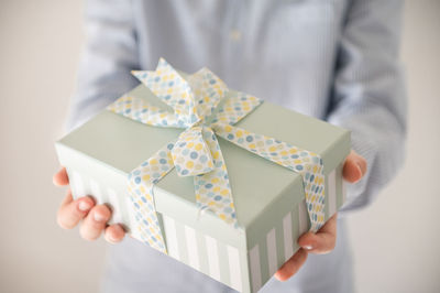 Midsection of man holding umbrella in box