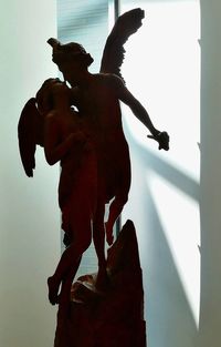 Low angle view of angel statue against sky