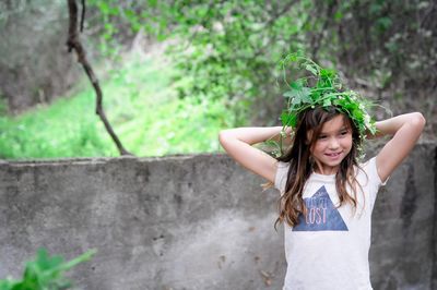 Smiling girl wearing plant