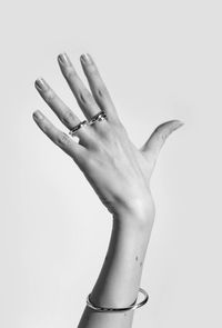 Close-up of woman hand over white background