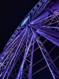 Low angle view of illuminated ferris wheel at night