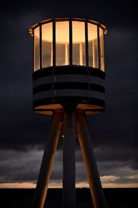 Low angle view of water tower against sky at sunset