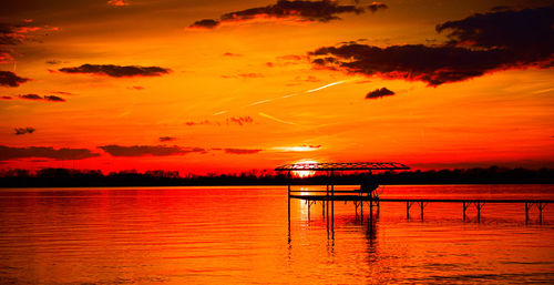 Scenic view of lake against orange sky