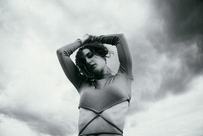 Low angle view of woman standing against sky