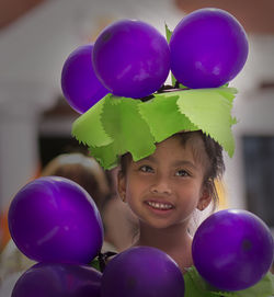 Close-up of happy girl in grape costume