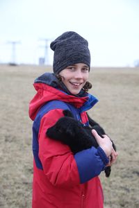 Portrait of smiling woman on field during winter