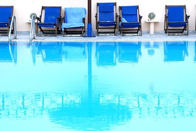 Low angle view of chairs in swimming pool