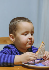 Portrait of cute girl eating food at home