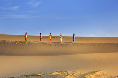 People on beach against sky