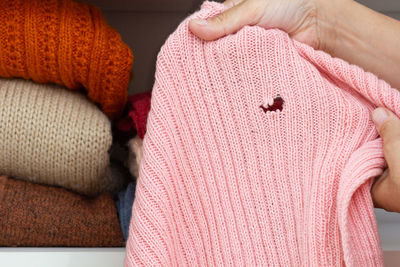 Midsection of woman holding sweater