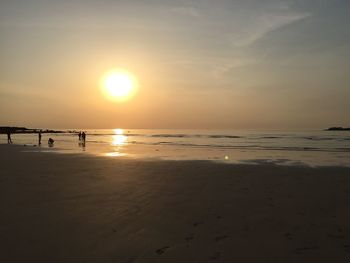 Scenic view of beach against sky during sunset