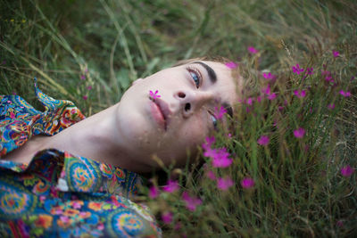 Close-up of man lying on grass