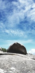 Low angle view of rock formations against sky