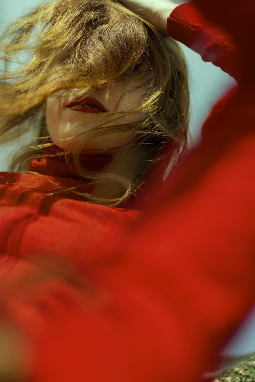 red, one person, hair, real people, blond hair, women, indoors, leisure activity, lifestyles, selective focus, hairstyle, lying down, high angle view, portrait, child, adult, relaxation, close-up, human hair, innocence