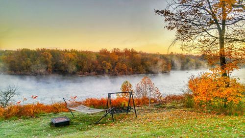 Scenic view of lake against sky at sunset