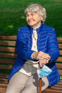 Man sitting on bench in park