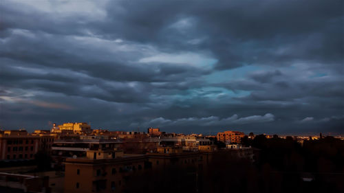 Cityscape against cloudy sky