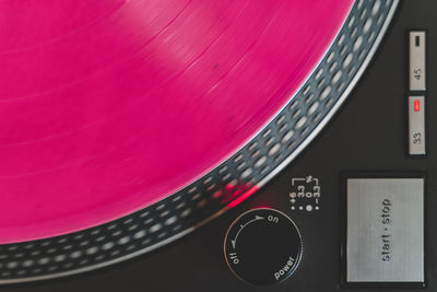 Close-up of electric bulb against pink background