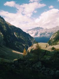 Scenic view of mountains against cloudy sky