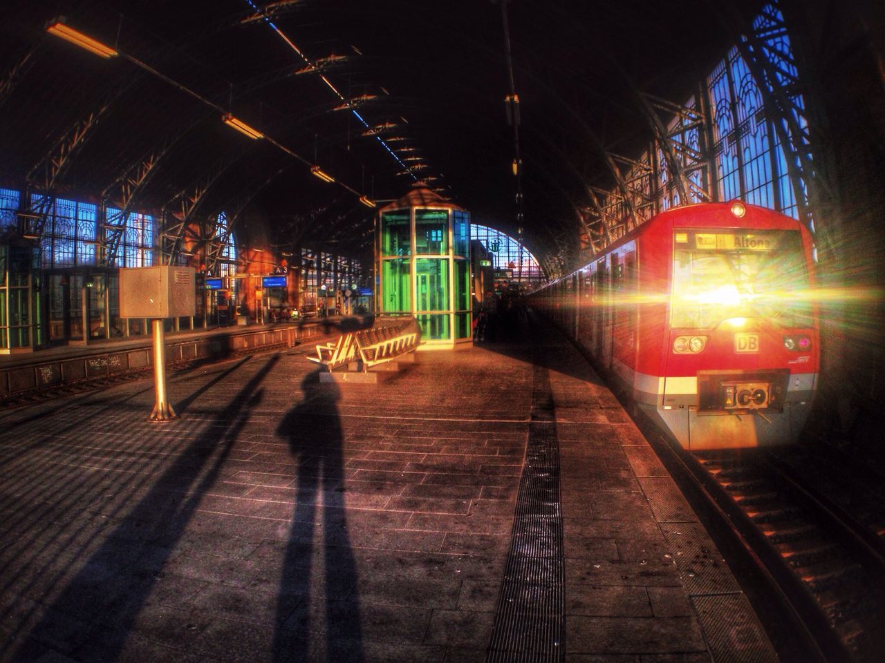 illuminated, transportation, the way forward, indoors, railroad station platform, railroad track, railroad station, night, walking, rail transportation, men, diminishing perspective, architecture, built structure, public transportation, lifestyles, rear view, full length