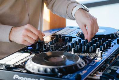 Midsection of man playing sound mixer