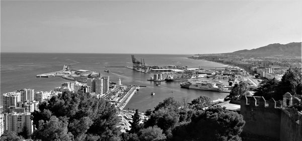 High angle view of townscape by sea against sky