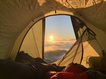 Tent against sky seen through window
