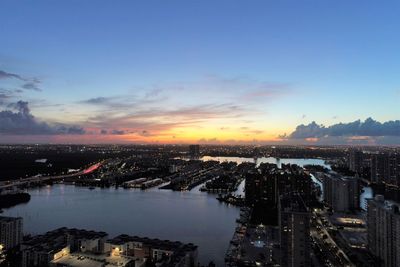 High angle view of illuminated buildings against sky during sunset