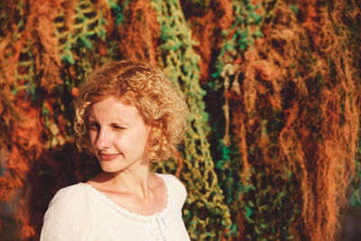 Woman standing against messy fishing nets