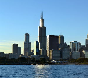 View of city by river against sky