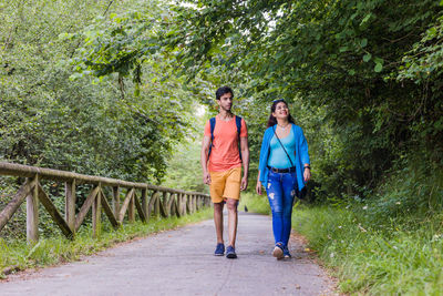 Full length of couple walking on footbridge