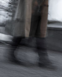 Low section of people walking on street