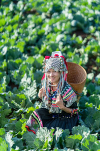 High angle portrait of woman in traditional clothing amidst farm