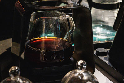 Close-up of drink in glass container at home