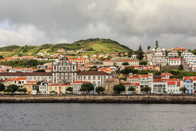 Town by sea against sky