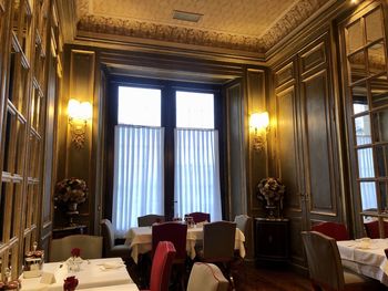 Empty chairs and table in building