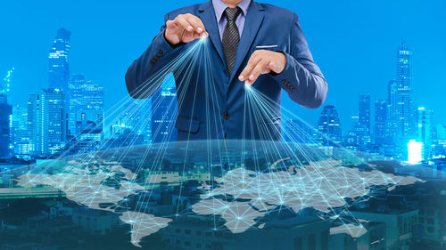 Digital composite image of businessman and world map