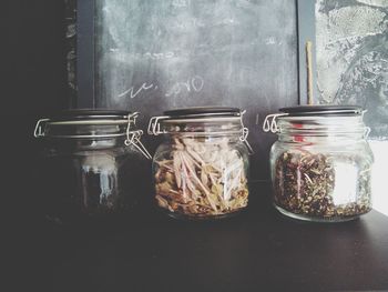 Spices in glass containers on table