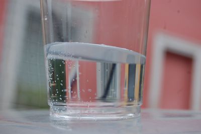 Close-up of wet glass on table