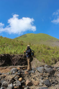 Man standing on mountain against sky