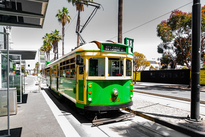 View of railroad tracks by street in city