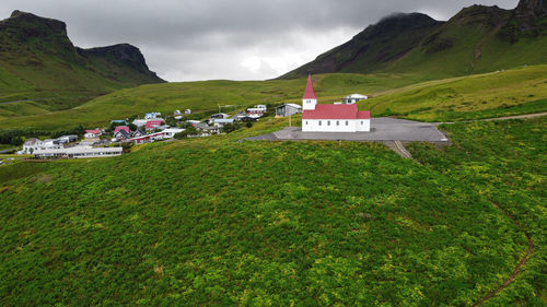 Scenic view of green landscape and mountains against sky