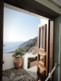 Scenic view of building against clear sky seen through window