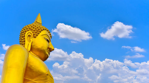 Low angle view of statue against blue sky