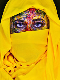 Close-up portrait of a woman covering face