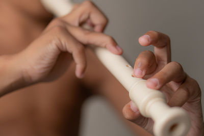 Cropped hand of woman holding equipment