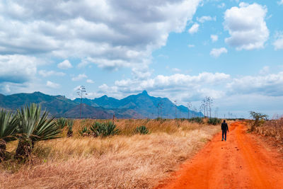 A man on a dirt road amidst sisal plants at uluguru mountains in morogoro, tanzania